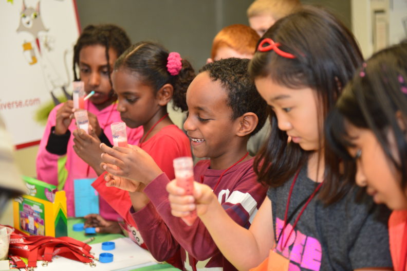 Dr. Universe teaches children how to extract DNA from strawberries during Kids Science and Engineering Day sponsored by the Society of Women Engineers.